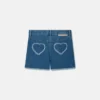 Short en denim stretch avec patch cœur à franges